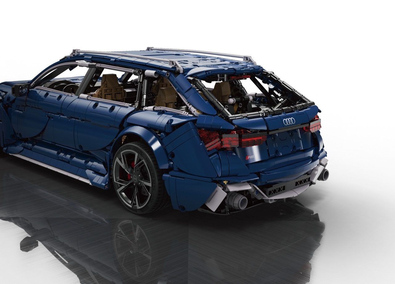 CaDA Audi RS6 Avant LEGO set in blue with open doors, tan interior, and detailed build visible.