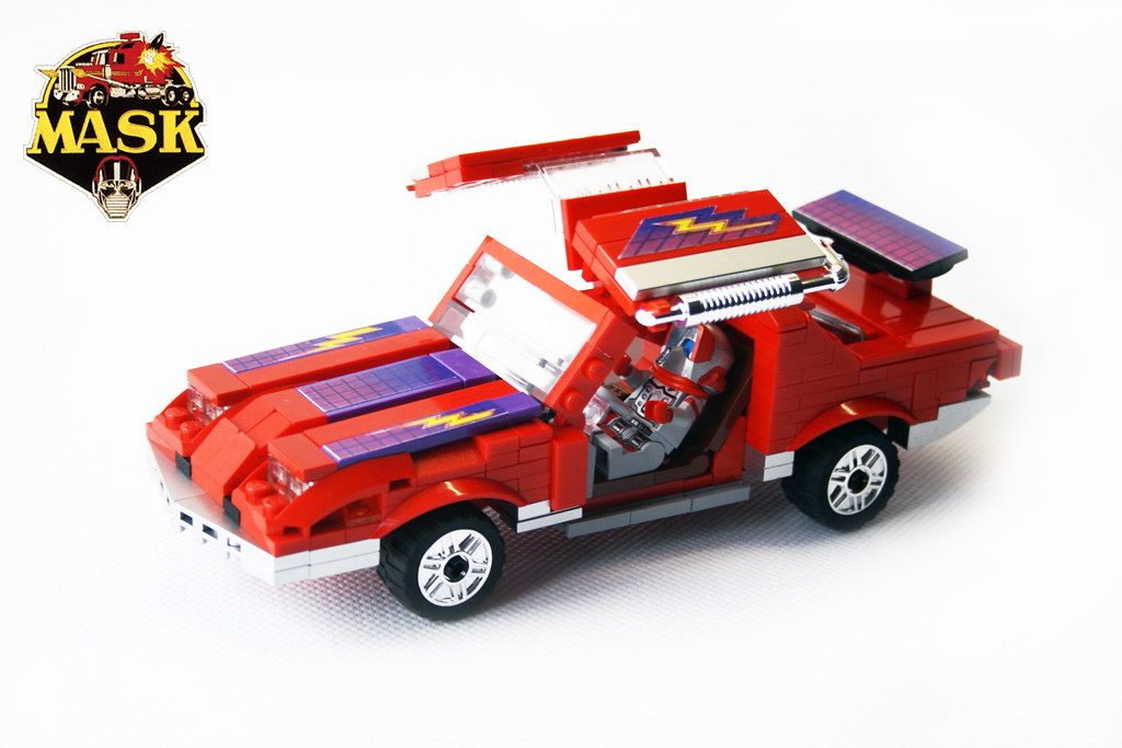 LEGO M.A.S.K. red vehicle MOC with opening canopy, solar panels, and white wheels displayed with official logo.