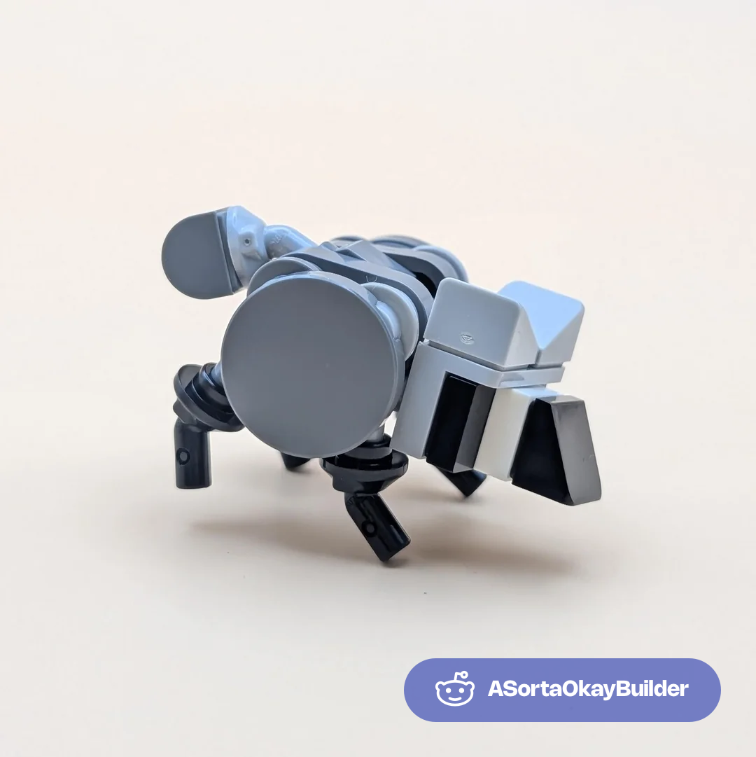 Mechanical LEGO raccoon with gray and black parts, articulated limbs, and distinctive round face piece.