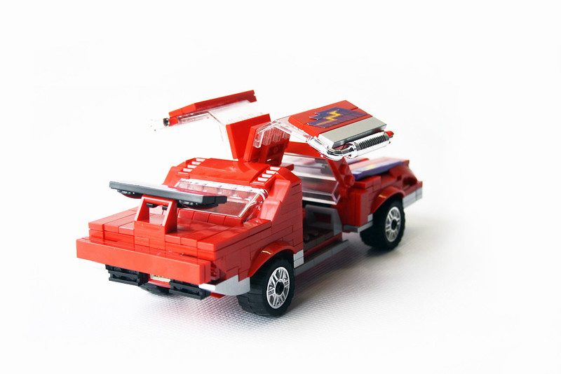 Red LEGO brick truck with opening hood, doors, and removable accessories in M.A.S.K. style MOC.
