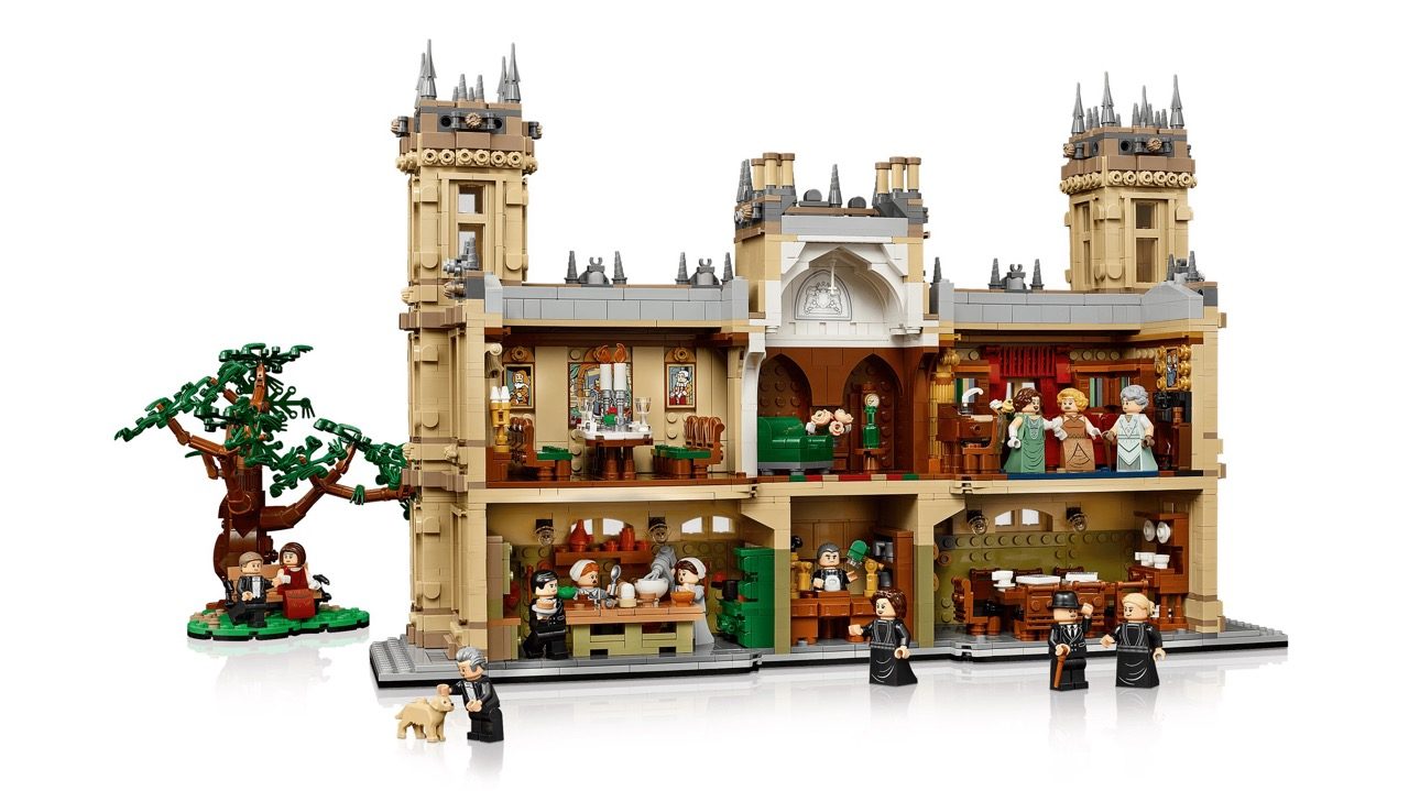 LEGO Downton Abbey set featuring Highclere Castle with towers, multiple rooms, minifigures, and decorative tree.