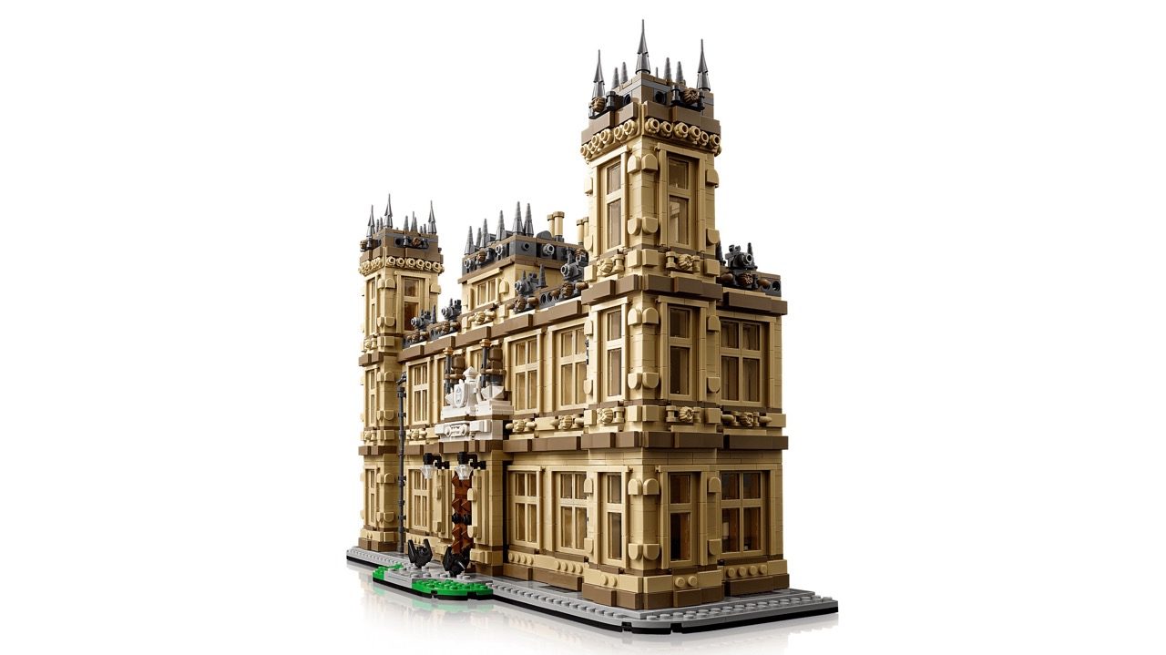 LEGO Downton Abbey set featuring detailed Highclere Castle model with tan brick towers, ornate architecture, and minifigures.