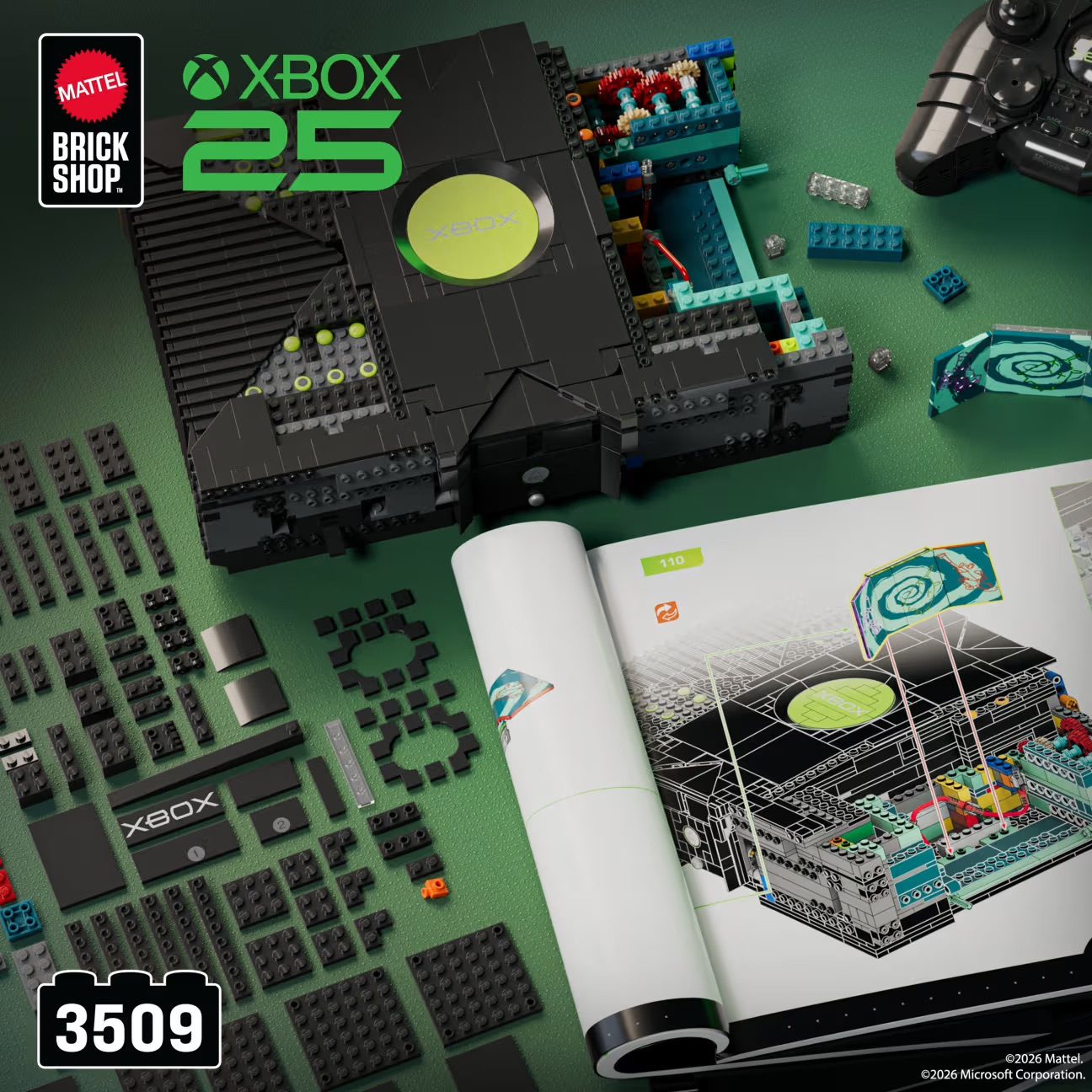 LEGO Xbox 25 set display featuring black console model, controller, instruction manual, and scattered bricks on green surf…
