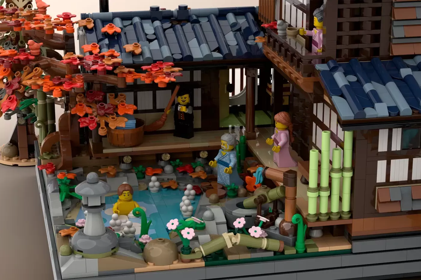 LEGO Japanese onsen autumn scene with minifigures, lantern, flowers, bamboo fencing, and traditional buildings with tiled …