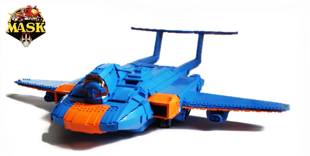Blue and orange LEGO M.A.S.K. aircraft MOC with cockpit, wings, and landing gear displayed against white background.