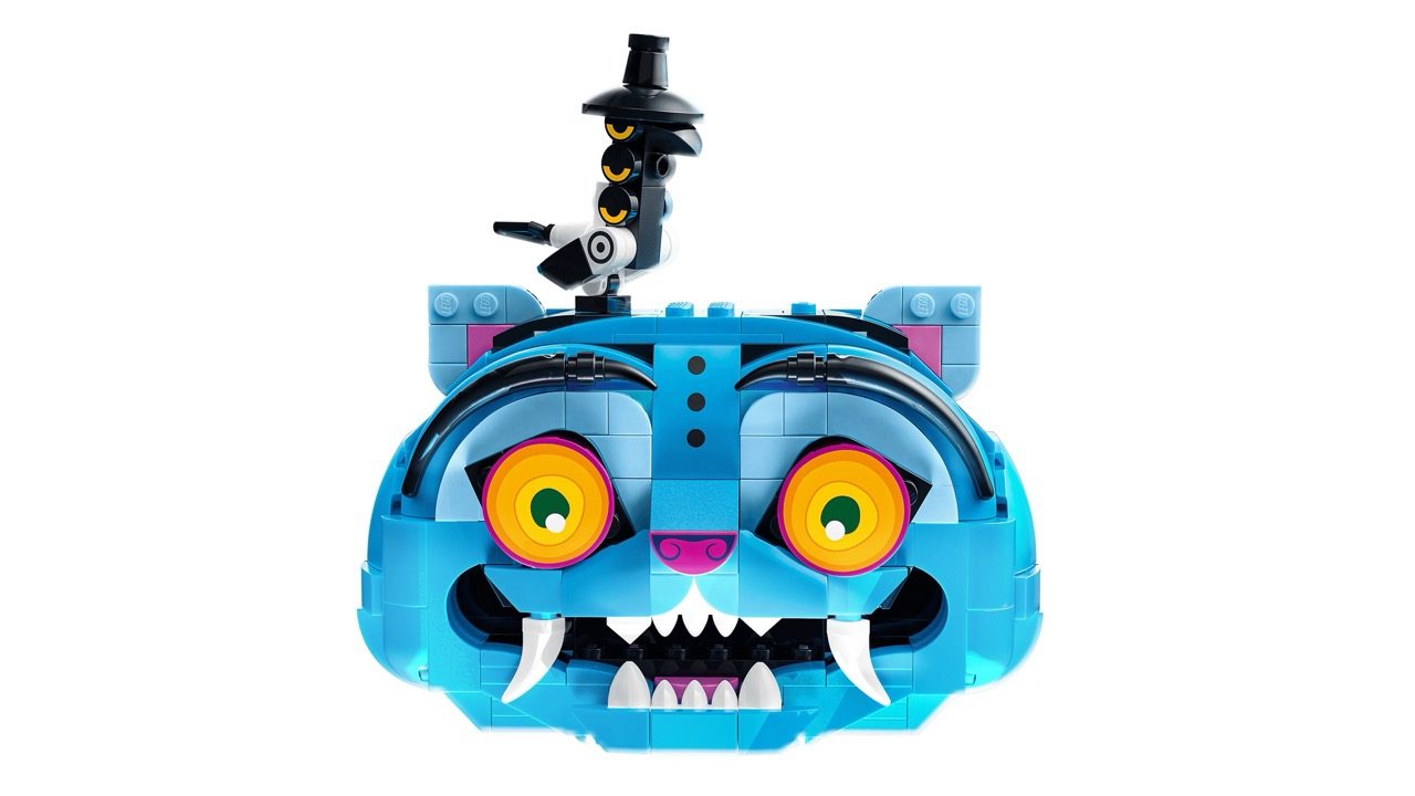 Blue LEGO buildable character head with large orange eyes, sharp teeth, and black demon hunter hat on top.