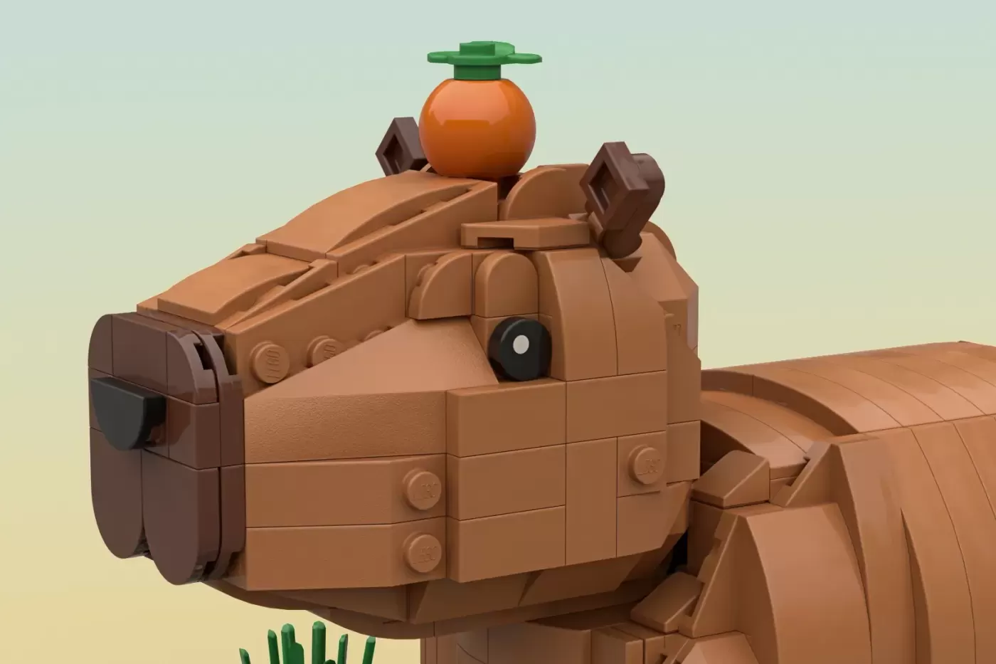 LEGO capybara sculpture with brown brick body, orange fruit on head, green plant stem, and small cactus detail.