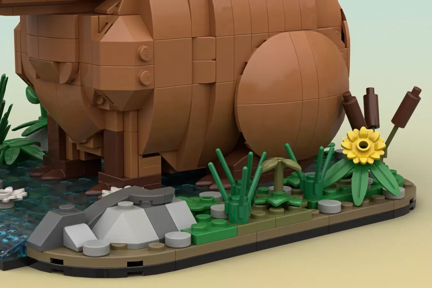 LEGO capybara build with barrel body, green plants, yellow flower, rocks, and water base in natural habitat setting.