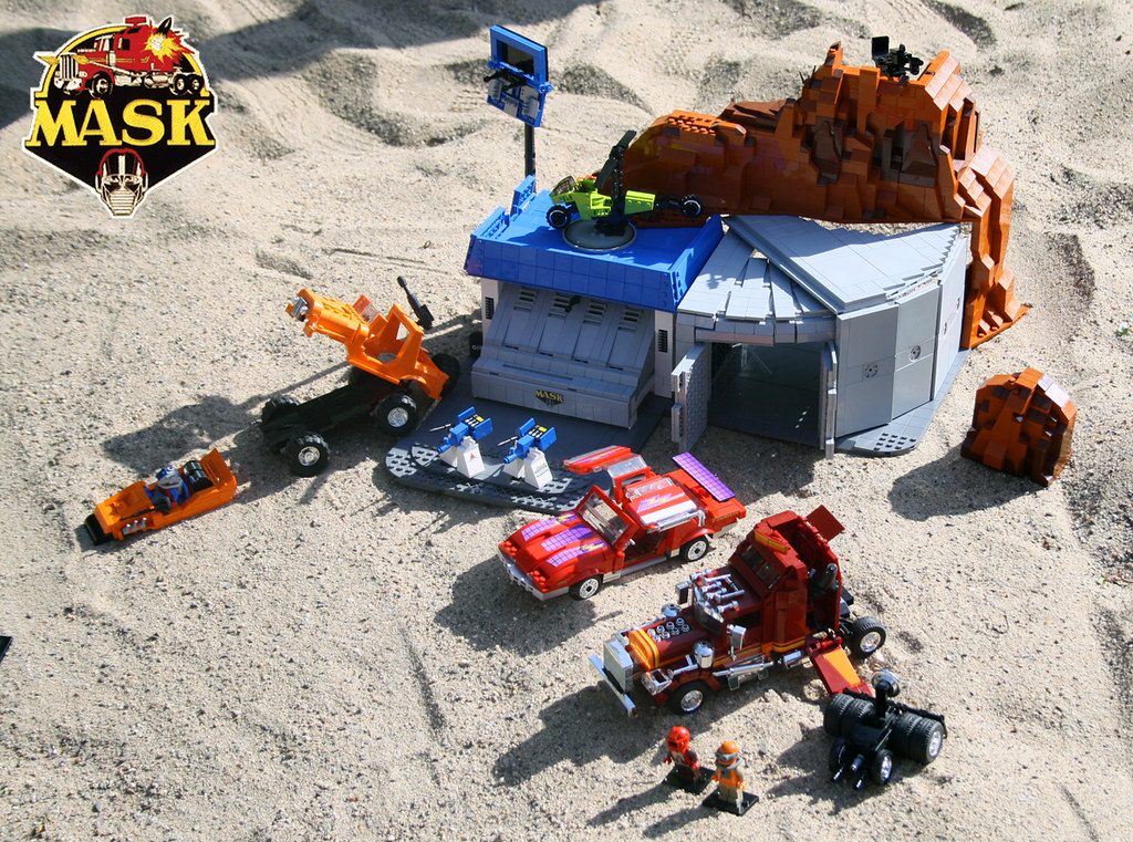 LEGO M.A.S.K. MOC featuring transforming vehicles, headquarters base, minifigures, and detailed sandy landscape setting.