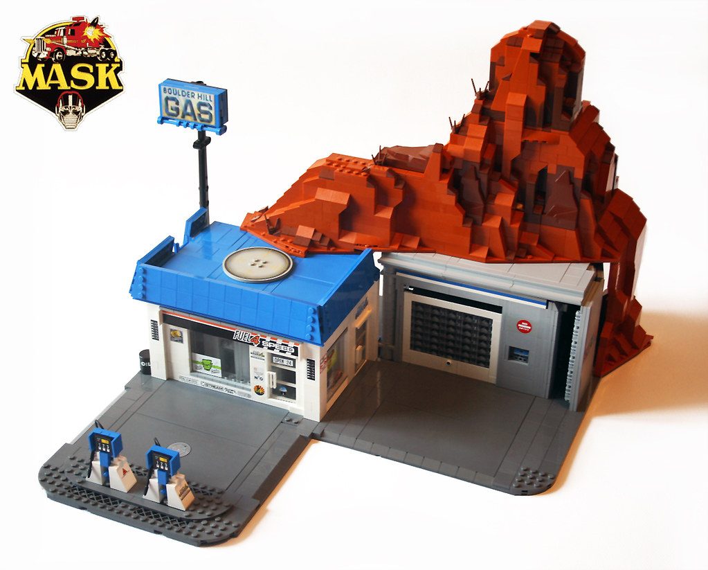 LEGO M.A.S.K. MOC featuring Boulder Hill base with gas station, red rock formation, and minifigures.