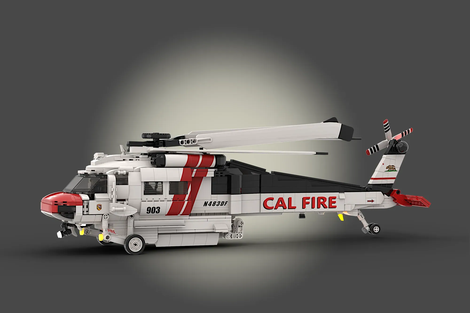 LEGO Ideas CAL FIRE Firehawk helicopter model with red and white livery, featuring rotors and landing gear.