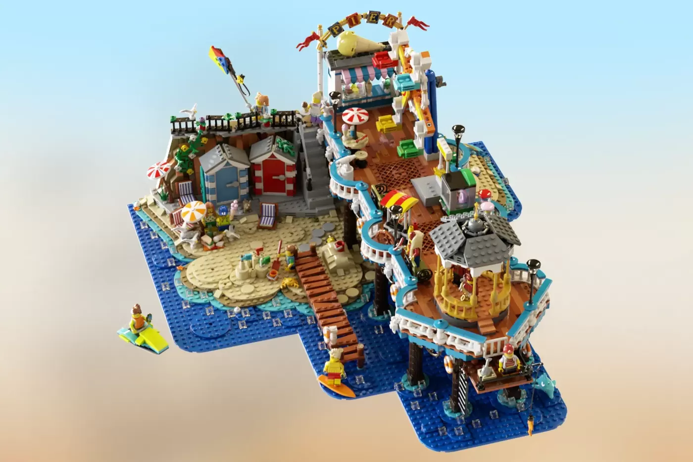 Victorian-style LEGO pier with colorful buildings, minifigures, beach baseplate, lighthouse tower, and seaside attractions.
