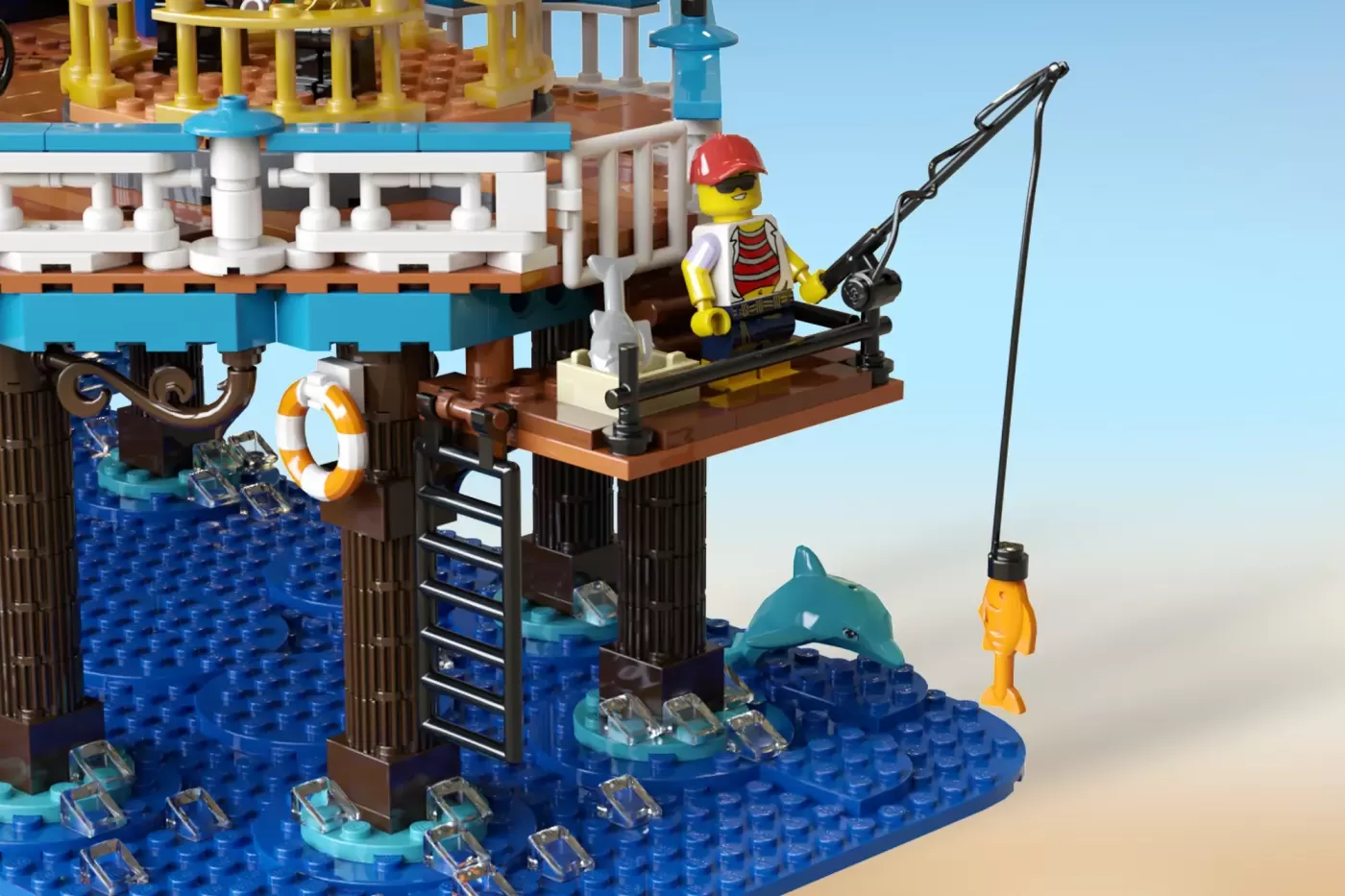 LEGO Victorian pier with minifigure fishing from dock, dolphin, life ring, and blue water baseplate.