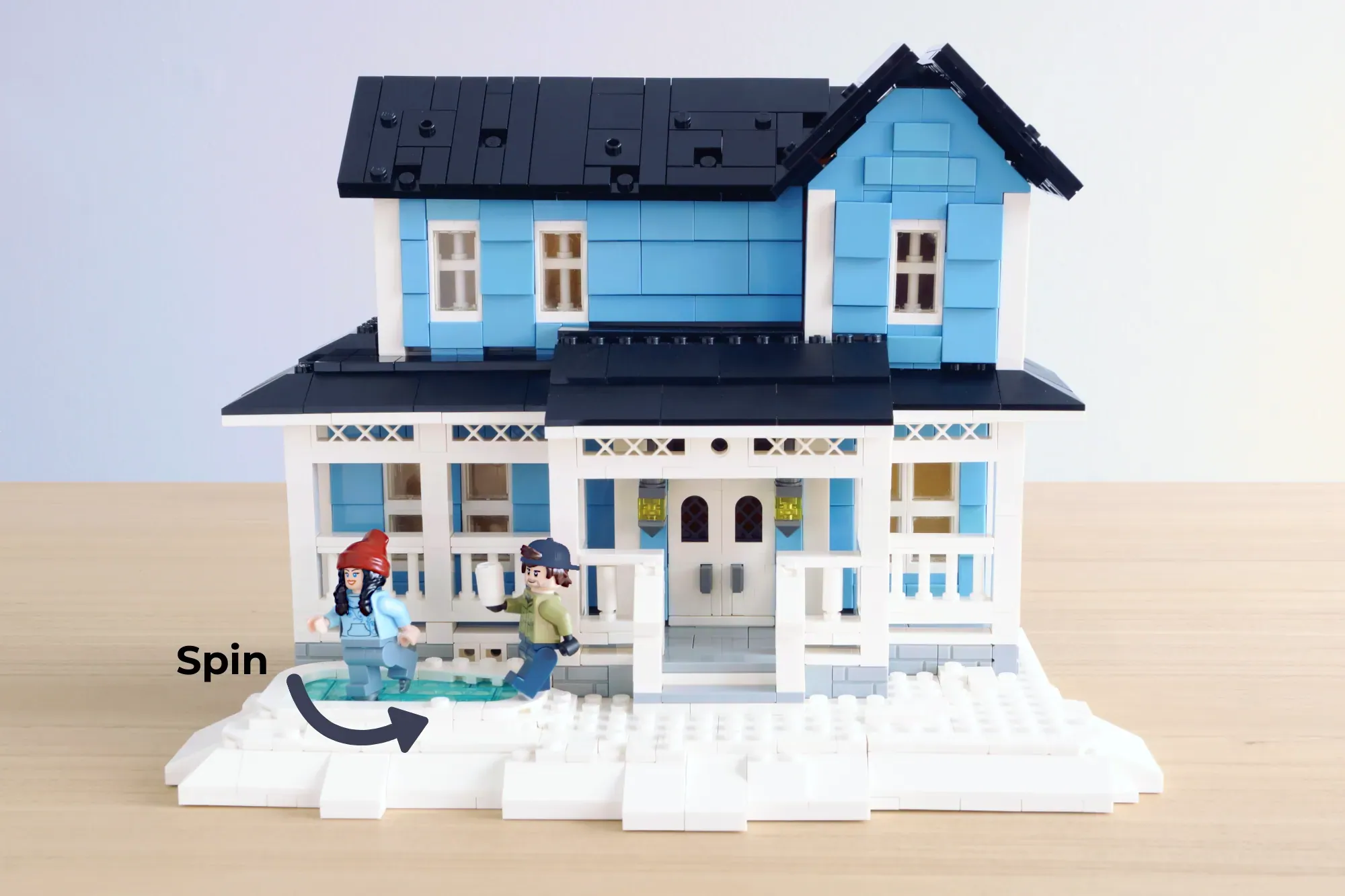 LEGO Stars Hollow house with blue exterior, white columns, black roof, two minifigures, and spinning base platform.