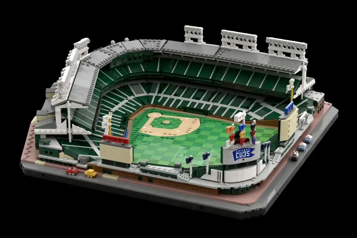 LEGO model of Wrigley Field baseball stadium with green seating, tan infield, and Chicago Cubs signage.