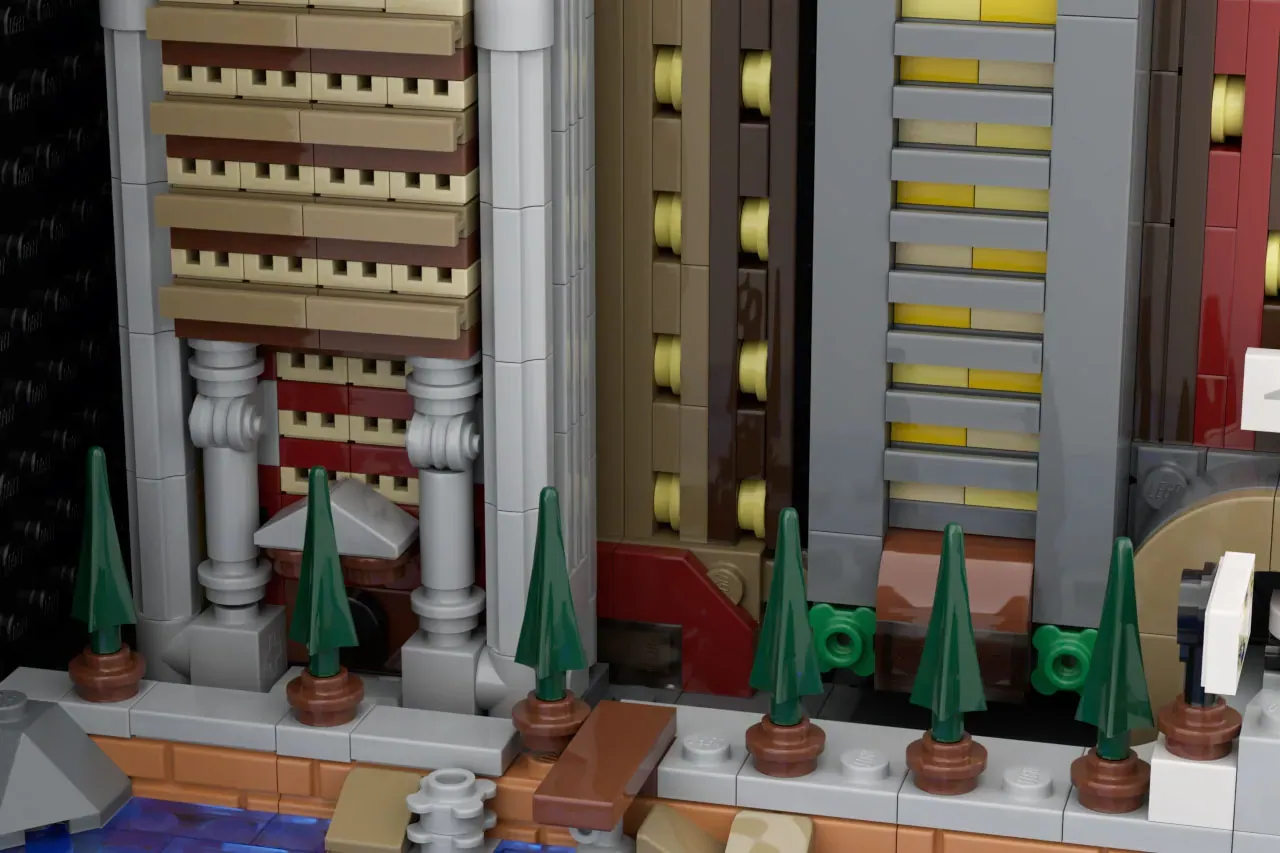 LEGO cityscape detail showing ornate buildings, columned architecture, and decorative green trees in planters along a street.