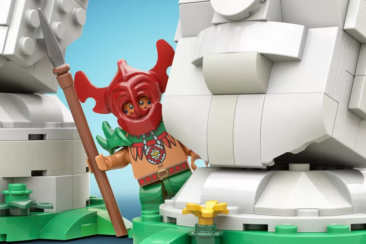 LEGO minifigure with red head and green body holding wooden staff near white LEGO structures and green base elements.