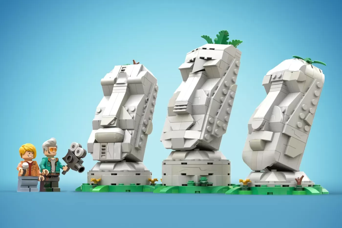 LEGO Moai set featuring three stone head sculptures with plants, minifigures, and camera, on green base.