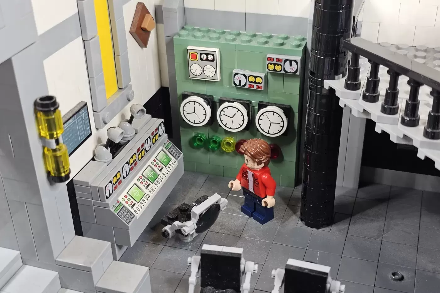 LEGO bunker control room with minifigure, clocks, monitors, and detailed sci-fi equipment displays.