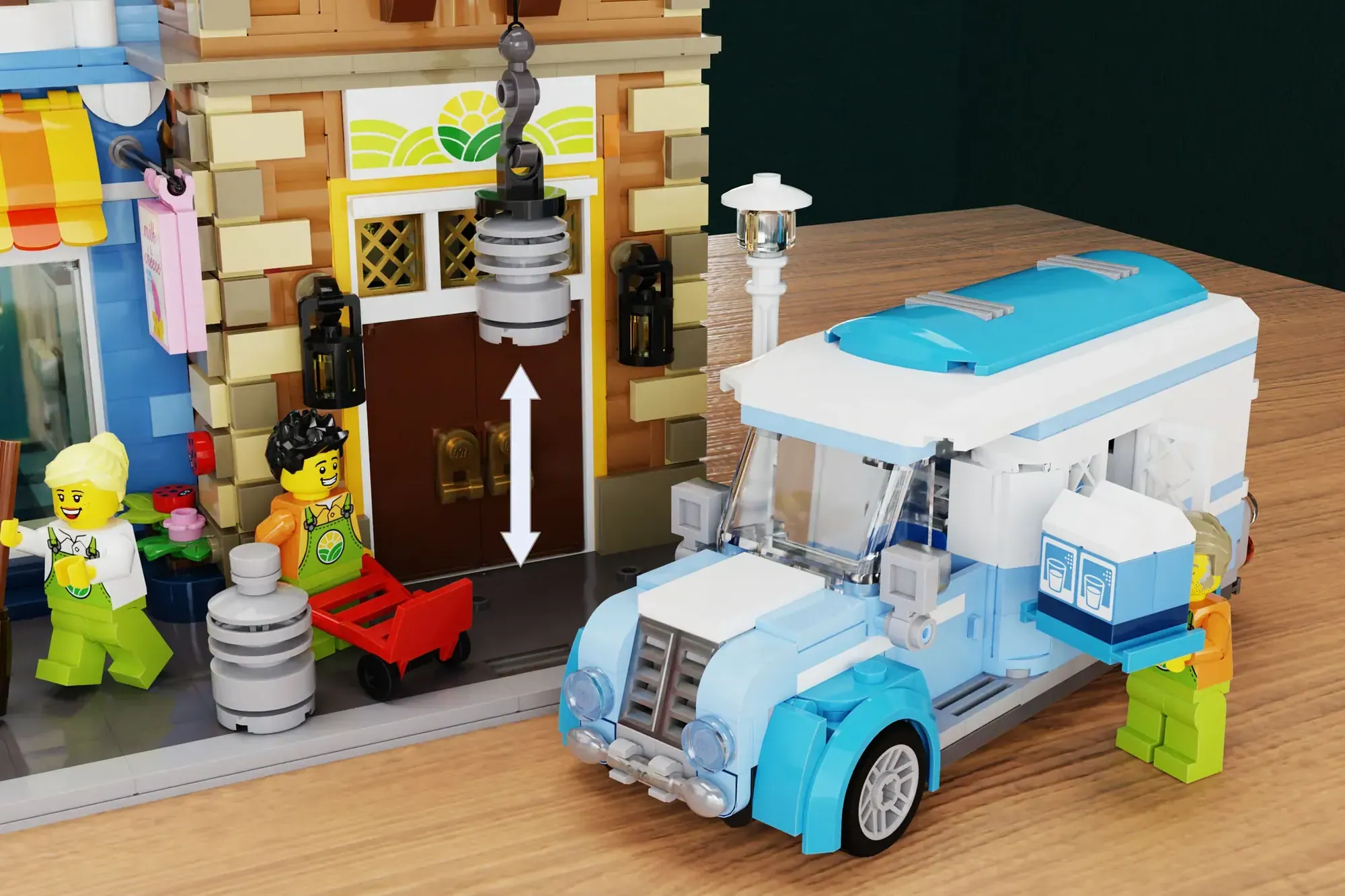 LEGO dairy shop set with blue delivery truck, modular building, minifigures, and accessories on wooden display surface.