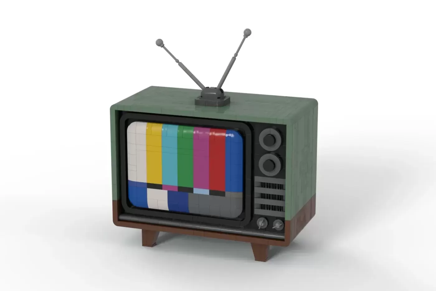 LEGO model of a vintage TV set with green top, brown wooden base, rabbit ear antennas, and colorful test pattern screen.