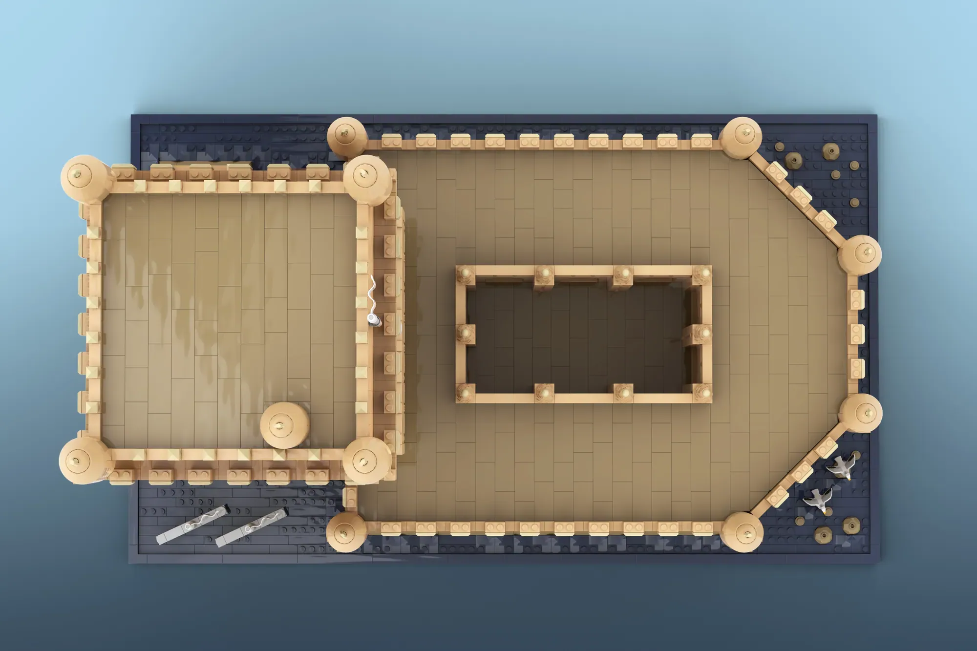 LEGO architecture model with tan brick walls, corner towers, and a central rectangular structure on dark baseplate.