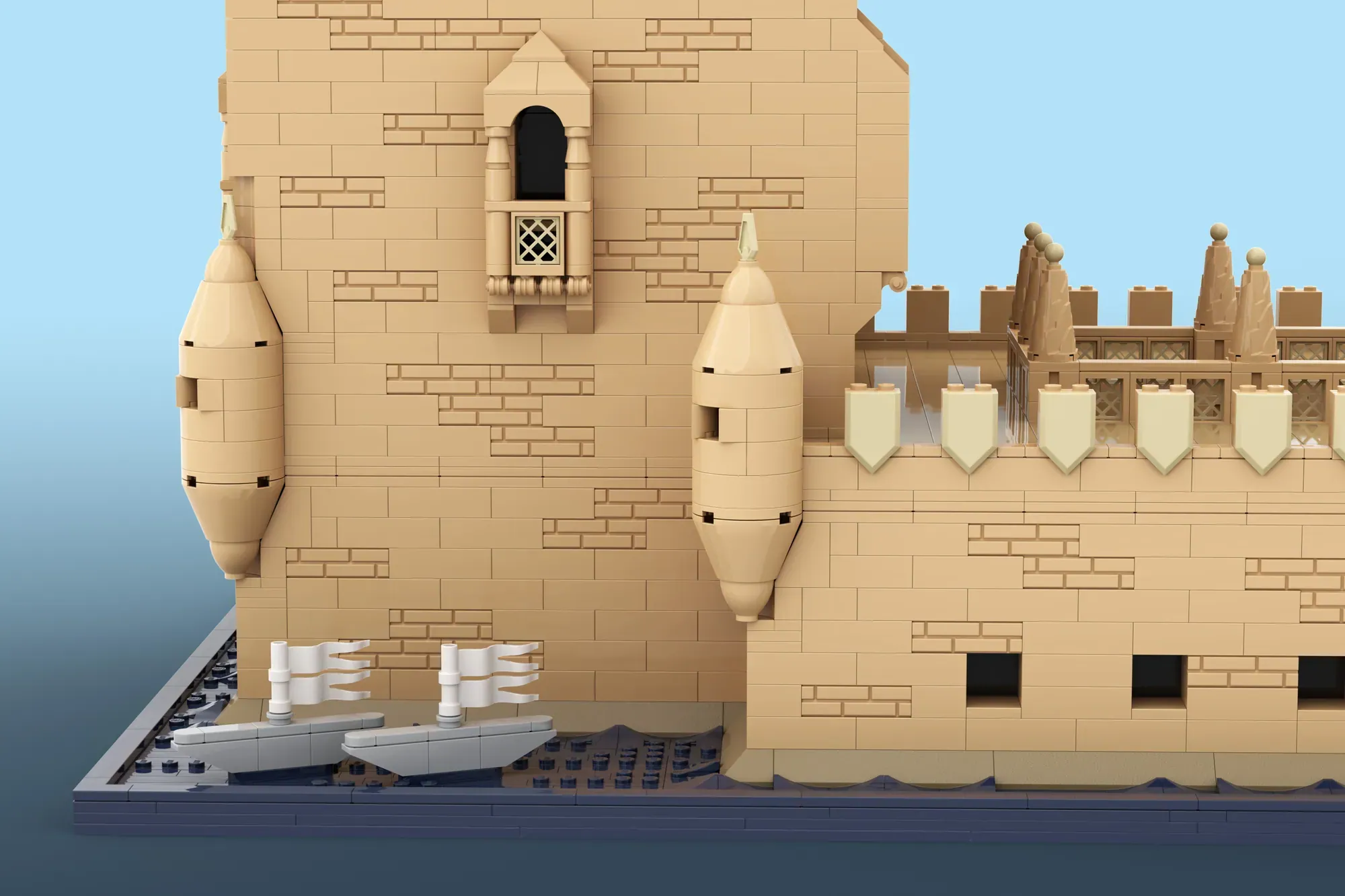 LEGO Torre de Belém model showing detailed brick walls, corner towers, crenellations, and arched water gate features.